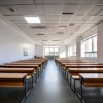 Firefly COLLEGE GALLERY CLASSROOMS WITH WHITE WALLS WITH DESKS AND BENCHES IN STEPS for students in